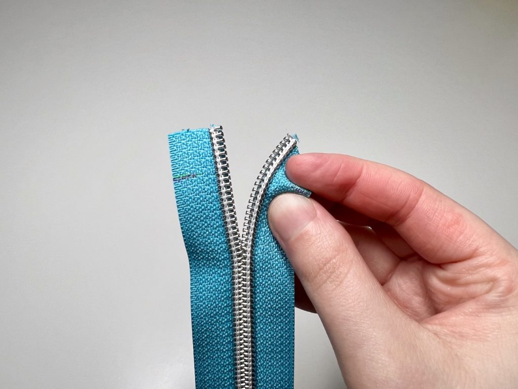 Pinch the zipper tape on the half inch mark