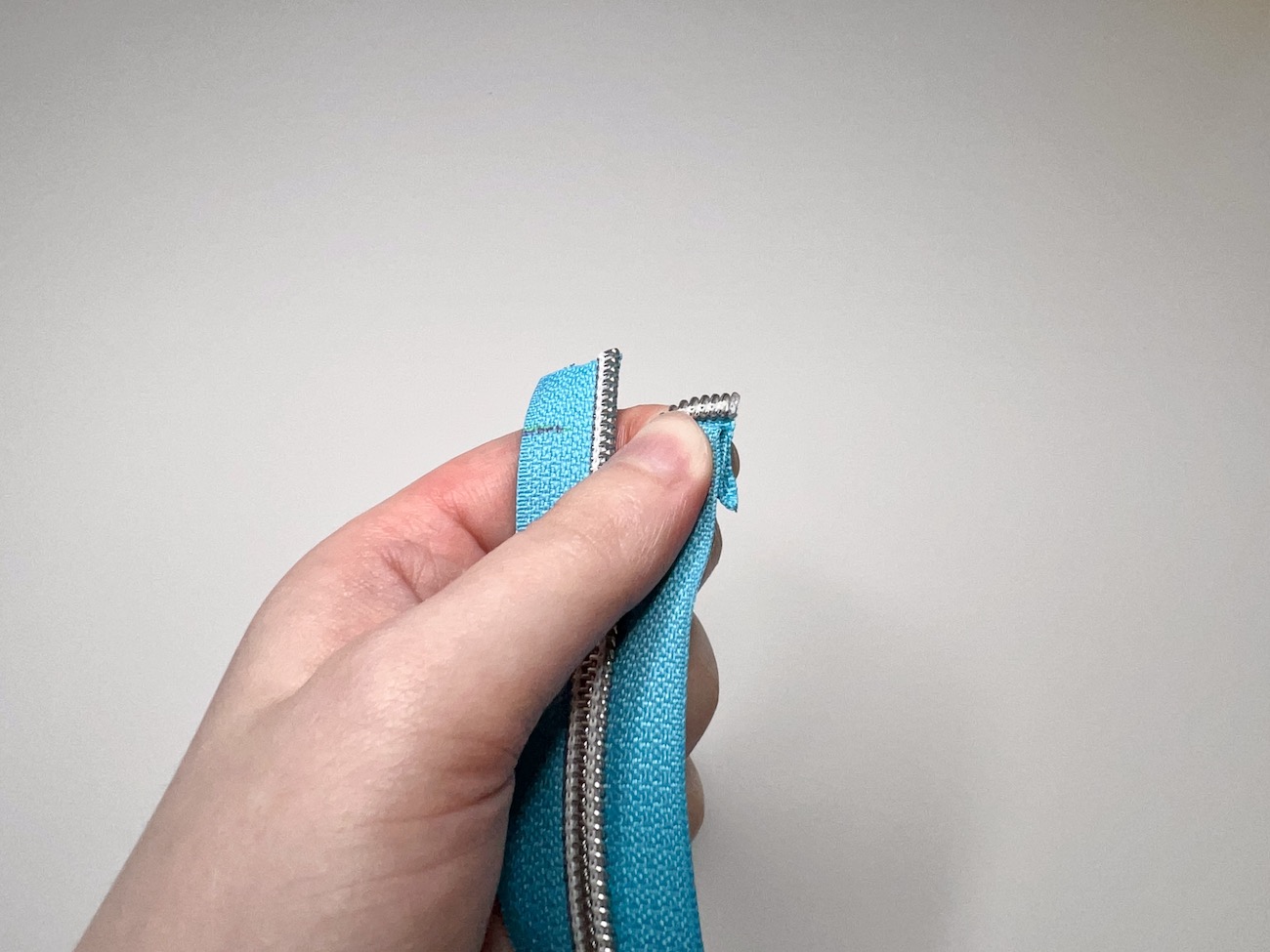 Pinched zipper tape on the half-inch mark from the front and side