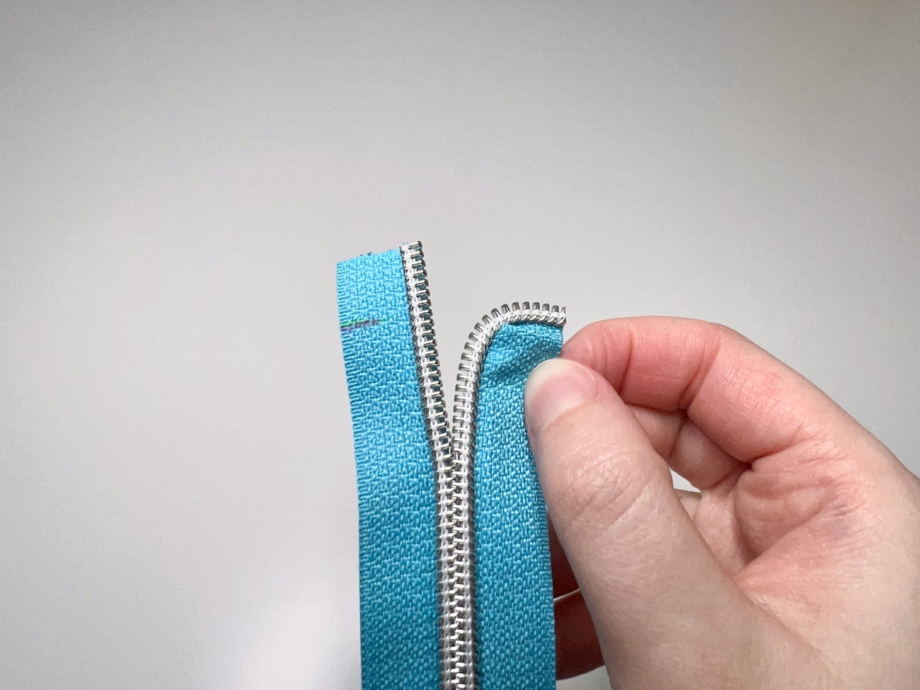 Pinched zipper tape on the half-inch mark from the front