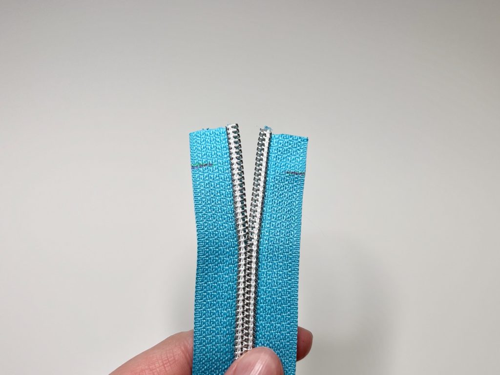 Zipper tape unzipped about one and a half inches from the cut side that has the half-inch markings