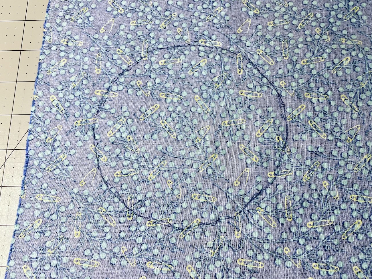 A pen traced circle of the candy dish on the wrong side of the fabric
